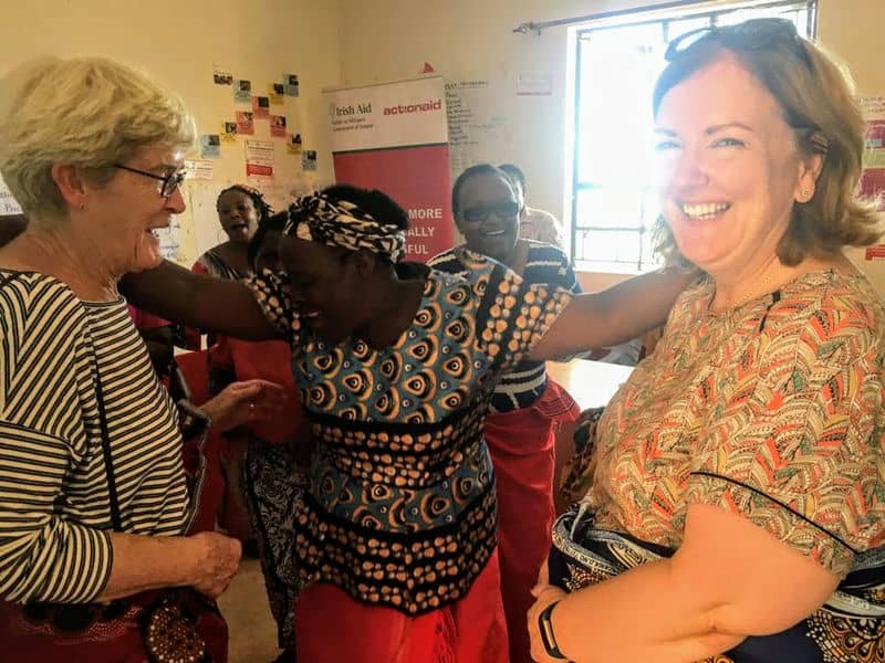 Women joyfully interacting at a community event, highlighting cultural connection and empowerment.