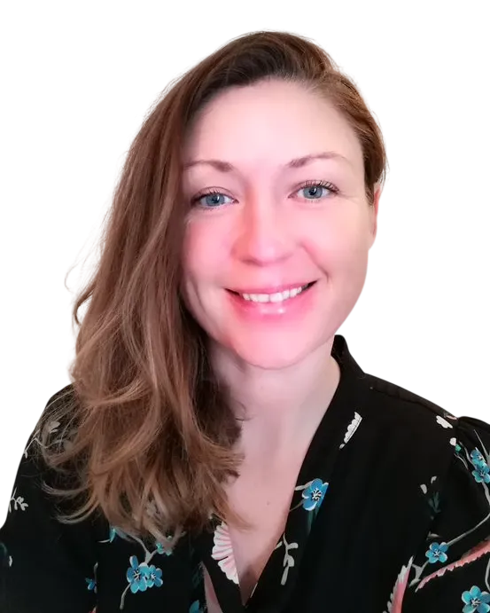 Smiling woman with long hair wearing a floral black blouse, isolated on a white background.