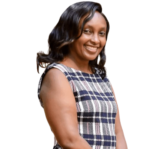 Smiling woman in a checkered dress, standing confidently against a white background.
